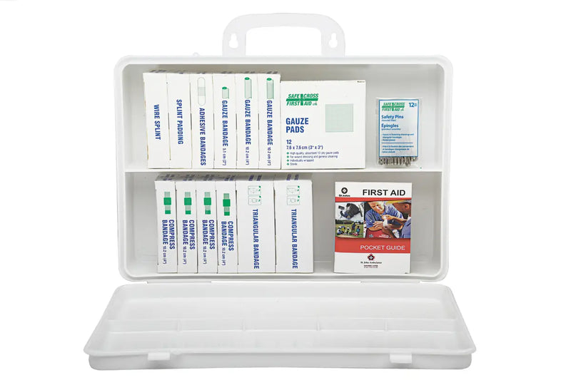 A plastic first aid kit for workplaces in Ontario, Canada, containing various bandages and medical pads.