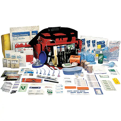 A trauma kit with various medical supplies spread out, including bandages, antiseptic wipes, and first aid equipment, with a large nylon bag.